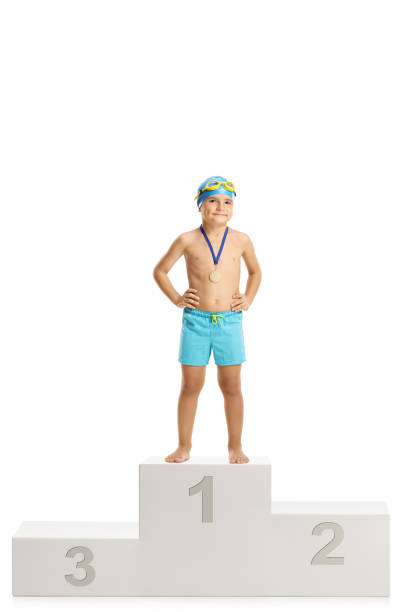 istock Cute boy swimmer on a winner's podium 1031341236