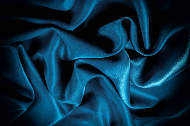 istock Texture, background. template. Silk fabric blue, Blue silk drapery and upholstery fabric from the courtyard - Dark curtains - Solid fabrics for backs and pillows 1031344584