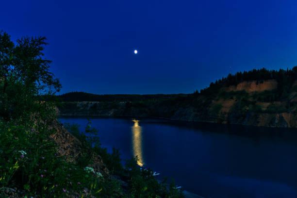 istock moon over a mountain lake in a summer night 1031348008