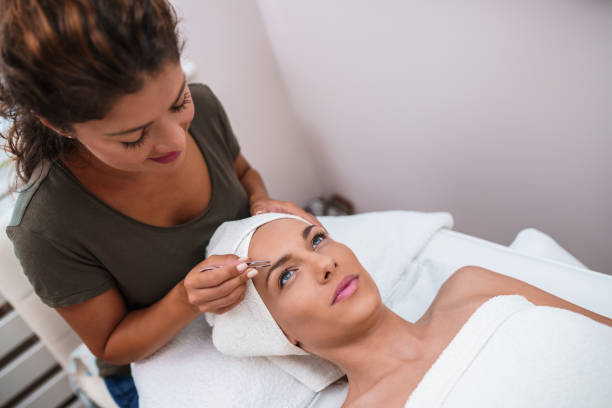 Beautiful young woman gets eyebrow correction procedure