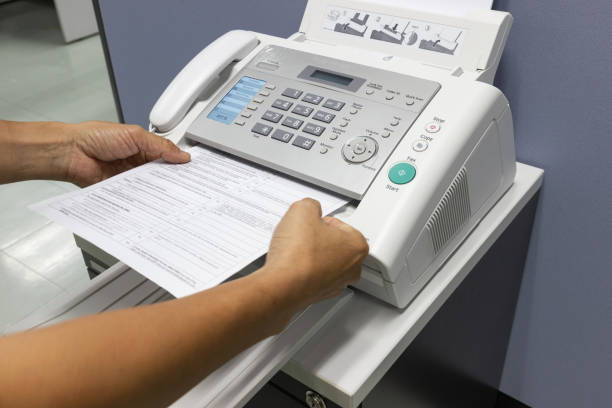 istock Hand man are using a fax machine in the office 1031358550