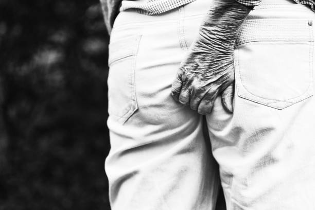 istock Senior hand scratching bottom through pants 1031358750