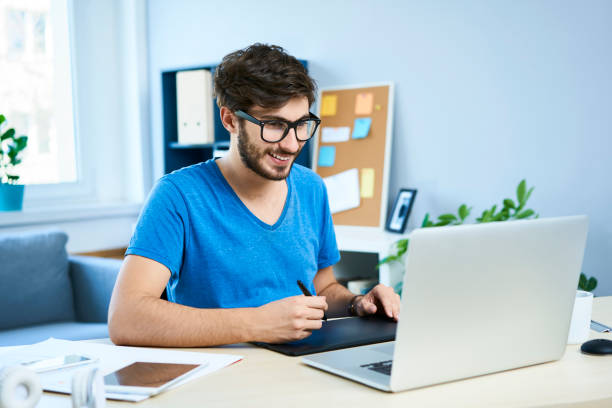 istock Young graphic designer in home office working on laptop 1031359084