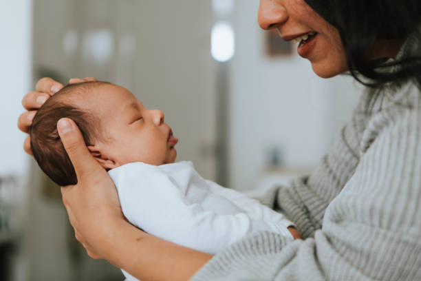 istock Mother holding her infant baby 1031362632