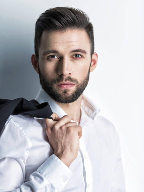 istock Handsome man in white shirt holds the black suit 1031366416