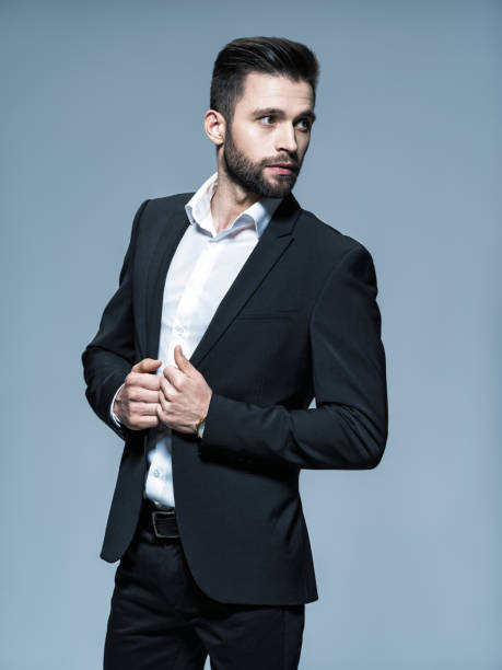istock Handsome man in black suit with white shirt 1031366440