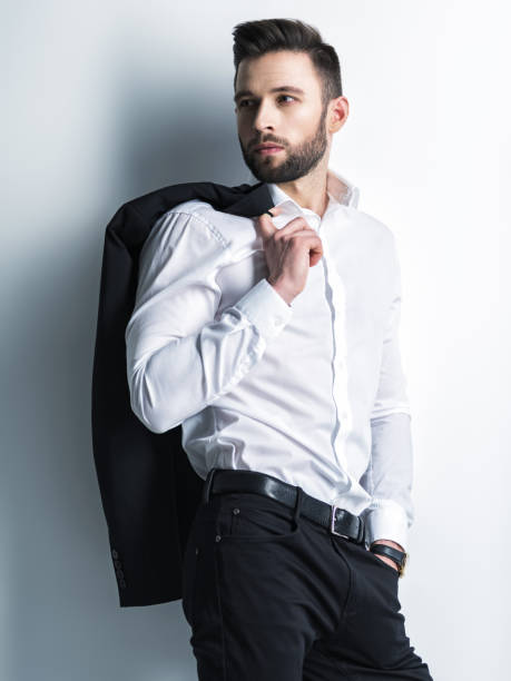 istock Handsome man in white shirt holds the black suit 1031366446