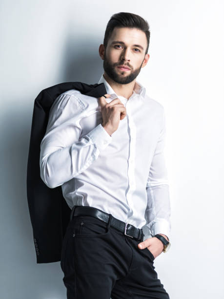 istock Handsome man in white shirt holds the black suit 1031366496