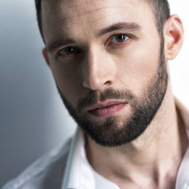 istock Handsome man in white shirt. Closeup portrait. 1031366532