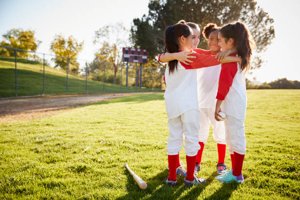 Happy Children United in Sports Team. Kids Building Team Spirit Altogether With a Coach. Boys in Red Uniforms Play Sports Game Outdoor