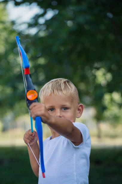 istock A little boy shoots out a toy bow 1031369654
