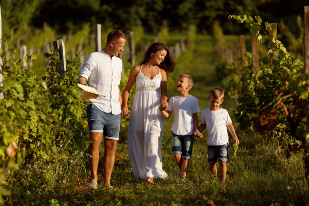 istock Family walking through a vineyard 1031375950