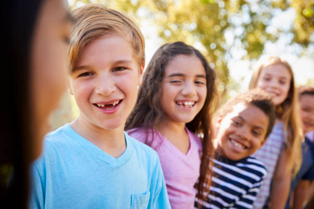 istock School kids hanging out together in a park 1031375984