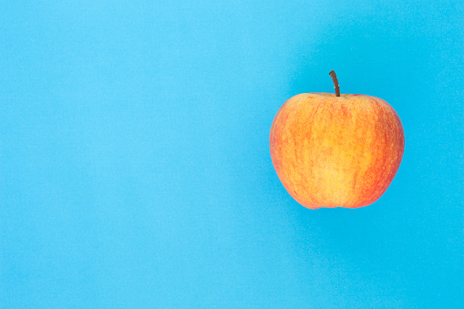 red apple top focus on blue background