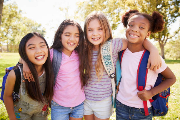 istock Four young smiling schoolgirls on a school trip 1031376296