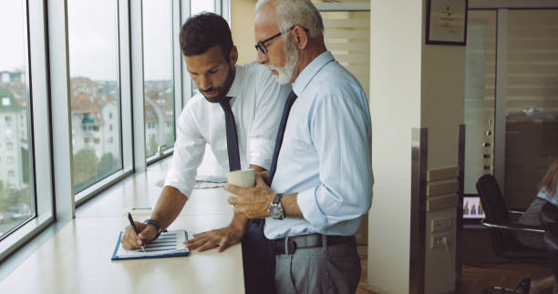 istock Senior boss consulting young subordinate 1031376422