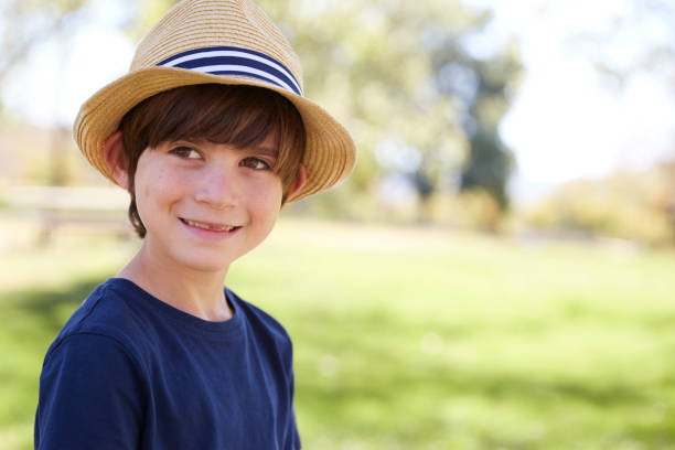 istock Young schoolboy in a sun hat smiling, close up portrait 1031376926