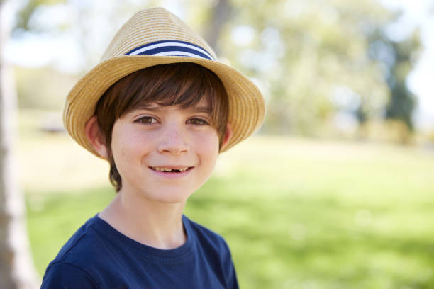istock Young schoolboy in a sun hat smiling to camera, portrait 1031376932