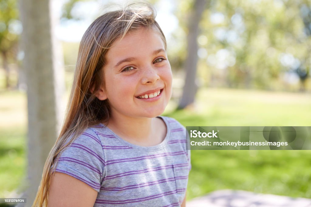 Young smiling schoolgirl looking to camera, close up portrait Girls Stock Photo