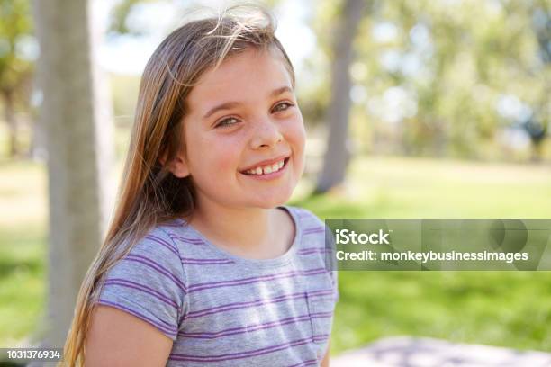 Young Smiling Schoolgirl Looking To Camera Close Up Portrait Stock Photo - Download Image Now