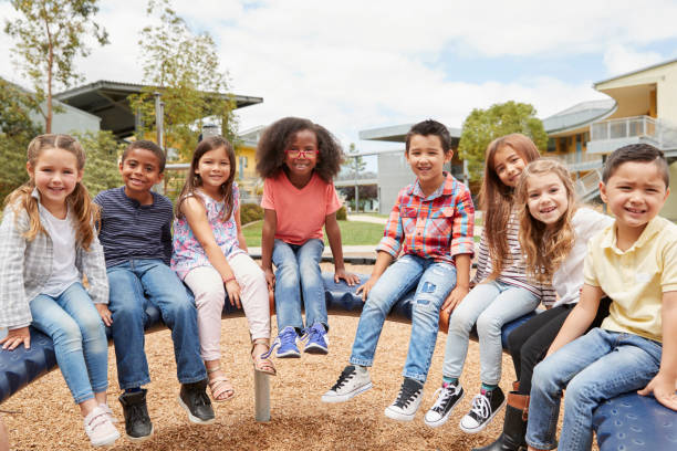 istock Elementary school kids sitting on carousel in the schoolyard 1031380416