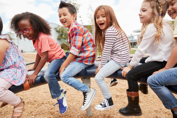 istock Kids playing on a spinning carousel in their schoolyard 1031380822