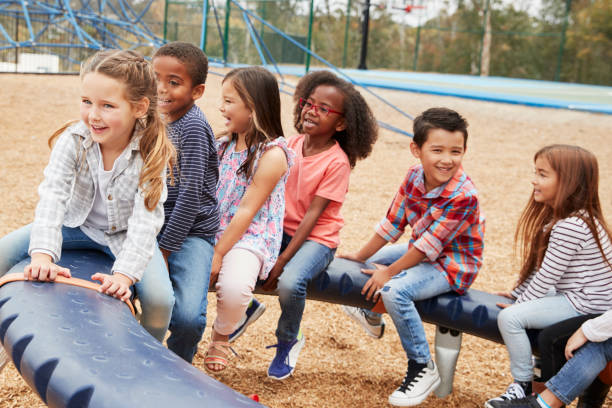istock Kids sitting on a spinning carousel in their schoolyard 1031380826