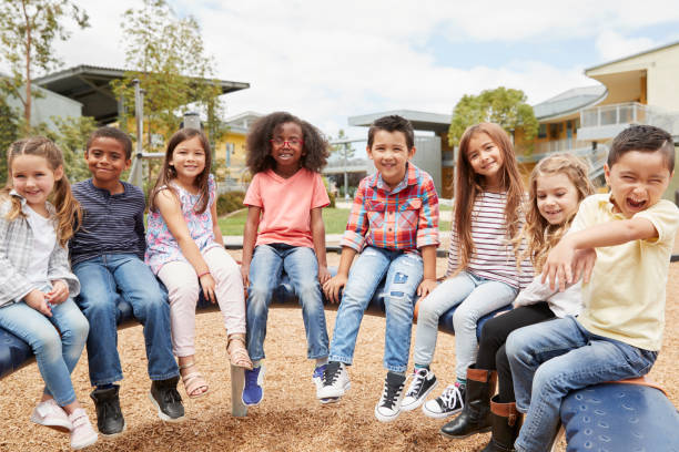 istock Elementary school kids sitting on carousel in the schoolyard 1031380836