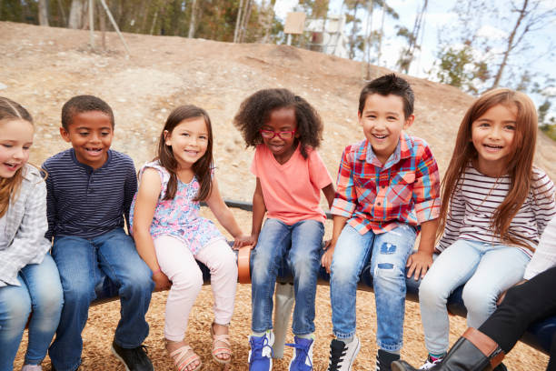 istock Kids playing on a carousel in schoolyard looking to camera 1031381466