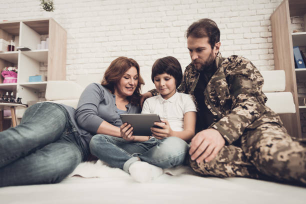 istock Disabled Man Soldier Watch A Tablet With Family. 1031381484