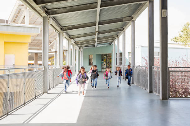 istock Young school kids running on a walkway in their school 1031385046