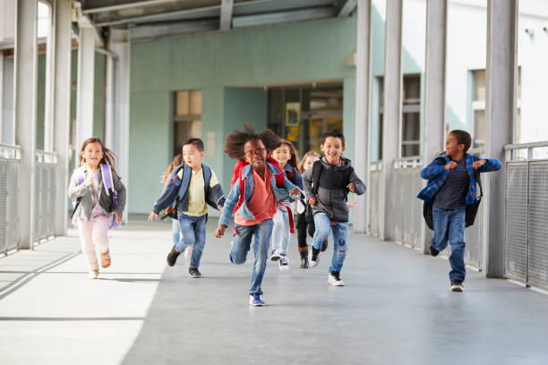 istock Elementary school kids running in a corridor in the school 1031389824