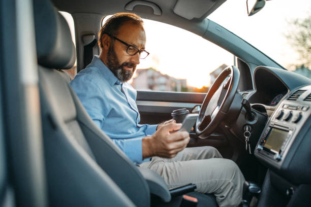 istock Business man text messaging in car 1031393782