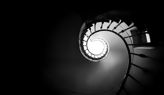 Ancient spiral staircase seen from below. Black and white shot