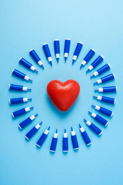 big red heart in circle of lancets on a blue background, World diabetes day stock photo