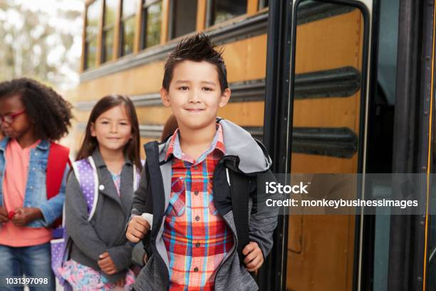 Elementary School Kids Queueing For The School Bus Stock Photo - Download Image Now - School Bus, Elementary Student, Child