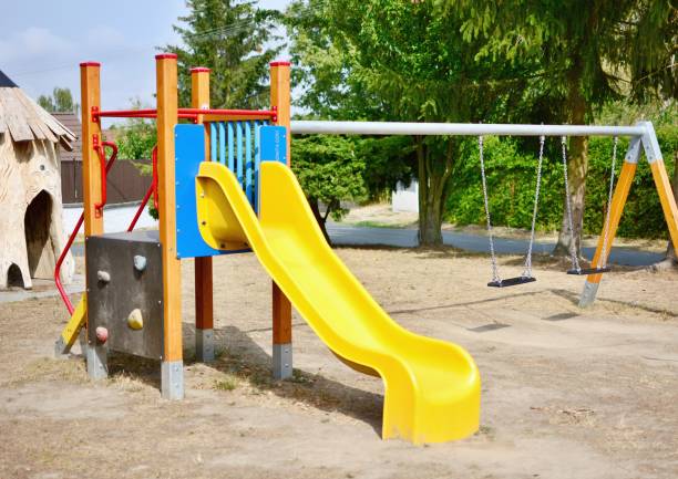 istock Playground with slide and swings 1031401236