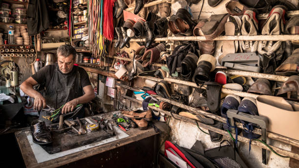 shaoemaker che lavora sulle scarpe nella storica città di adiyaman, storico bazar di oturakci all'interno della città vecchia, turchia - adiyaman foto e immagini stock