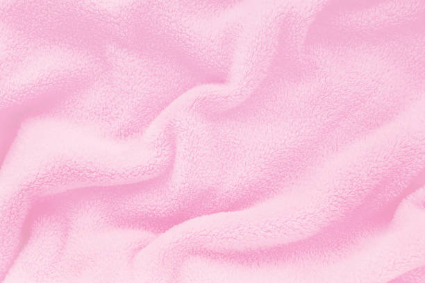 Fluffy Gentle baby pink fabric with waves and folds. Soft pastel textile texture. Folds on the soft fabric. Rose towel terry cloth. Fluffy Gentle baby pink fabric with waves and folds. Soft pastel textile texture. Folds on the soft fabric. Rose towel terry cloth. fleece photos stock pictures, royalty-free photos & images