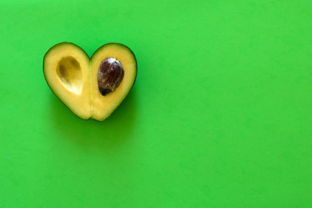 istock Heart-shaped avocado on  green background 1031411374