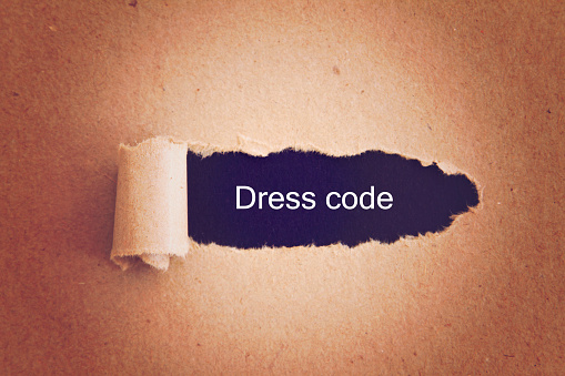 Dress Code written under torn paper.