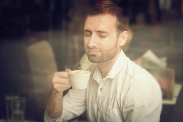 istock Young man sitting in coffee shop 1031416116
