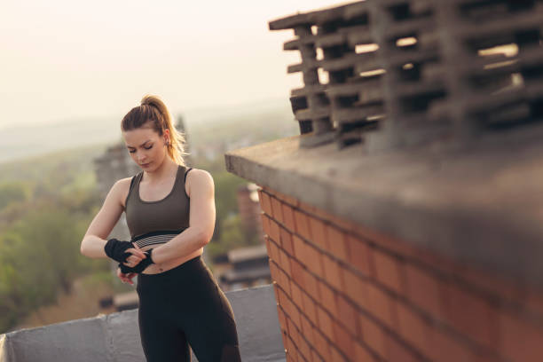 istock Woman wrapping hands with bandages before workout 1031418212