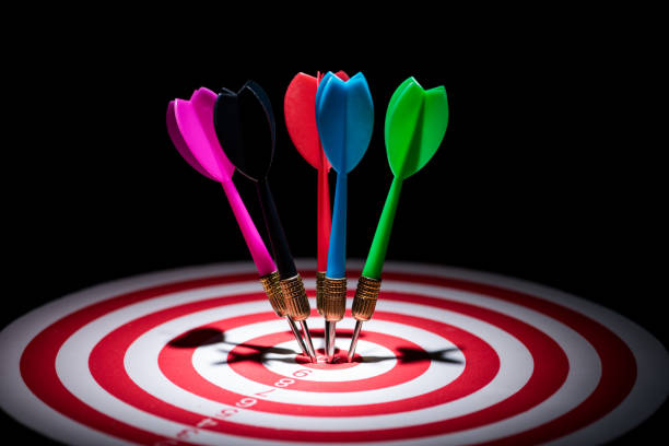 istock Close-Up Of Multi Colored Darts On Board Against Black Background 1031418410
