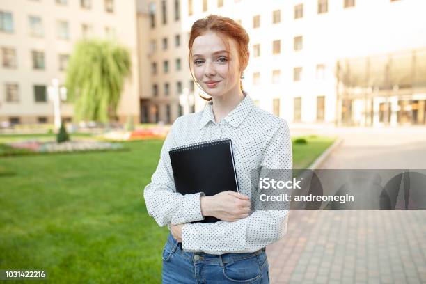 Beautiful Red Haired Girl With Freckles Hugging Notebooks With Homework And Smiling Happy Back To School Concept Portrait Of A Student Stock Photo - Download Image Now