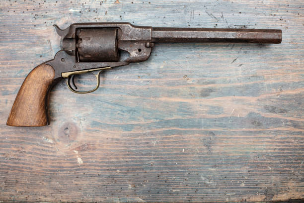 A historical pistol on vintage wooden table stock photo