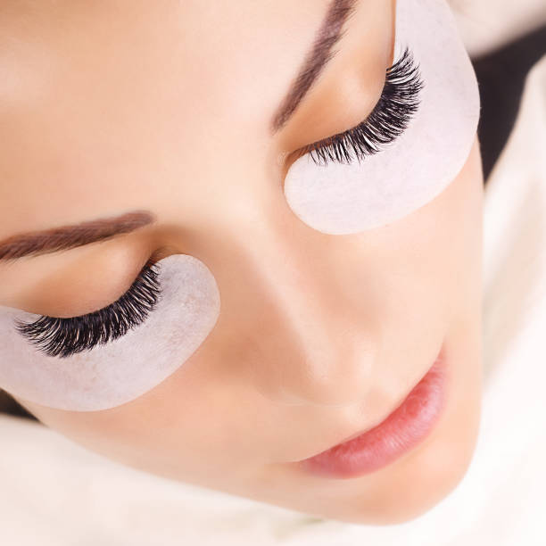istock Eyelash Extension Procedure. Woman Eye with Long Eyelashes. Close up, selective focus. 1031432808