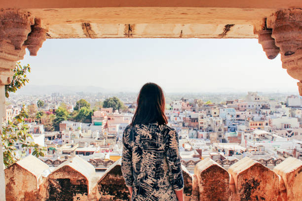 Admiring the City of Udaipur A young woman looks out over the city of Udaipur, Rajasthan, North India. india tourism stock pictures, royalty-free photos & images