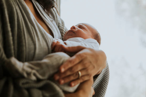 istock Mother holding her baby indoors 1031437072
