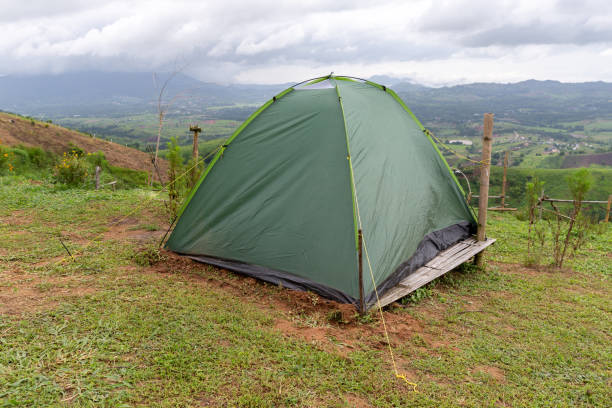 istock A small green tourist tent on grassy valley on mountain. 1031445018
